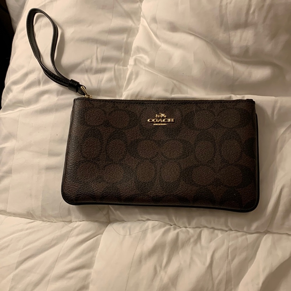 Coach wristlet. Brown with signature Coach “C” and gold colored logo